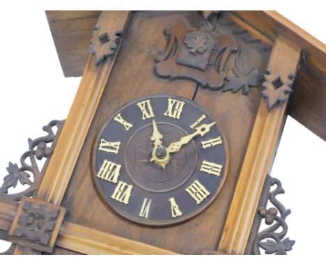 A late 19th/early 20thC black cuckoo clock, the dial with Roman numerals, 35cm high.