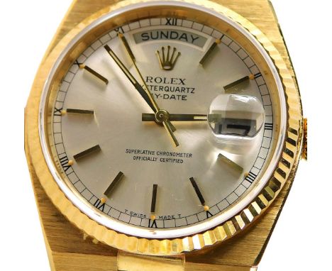 A Rolex Oyster Quartz Day-Date, in 18ct gold case with 18ct gold strap, model no. 19018, serial no. 6158810, with original pa