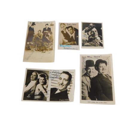 A collection of photographs of film stars, each bearing signatures, to include Laurel and Hardy, Charly Wood, etc., some poss