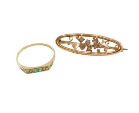 An emerald and diamond ring, set with three pairs of square cut emeralds interspersed with pairs of tiny diamonds, one emeral