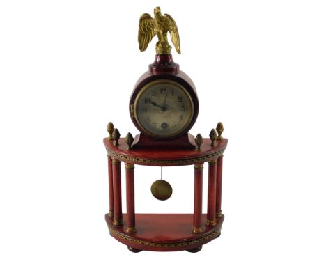 An early 20thC French style red stained mahogany and gilt metal portico time piece, with eagle finial, 34cm high.