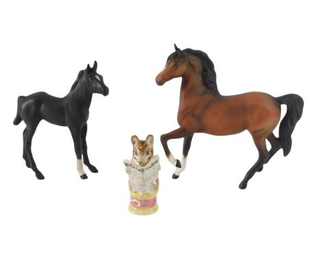 A Beswick matt glazed model of a horse, with leg raised, 16cm wide, a Beswick black matt glazed foal, 14cm long, and a Beatri