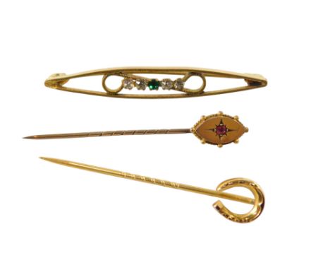 A horseshoe tie pin, yellow metal, stamped 9ct, further tie pin set with a red coloured stone, 1.6g, and a further brooch, se