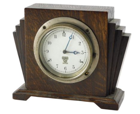 A Smiths car clock, the dial engraved 130964, in later Art Deco oak case, 24cm wide.