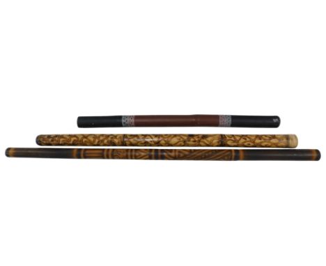 Three decorated Aboriginal souvenir didgeridoos.