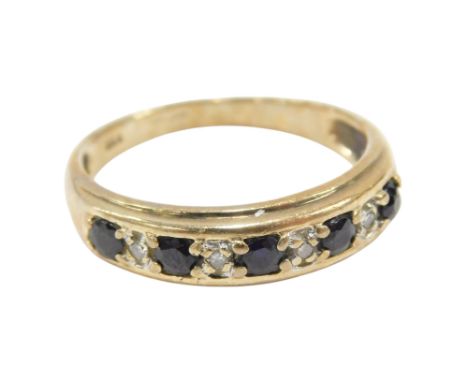 A 9ct gold sapphire and diamond nine stone ring, in a rub over setting, size O, 2.4g. 
