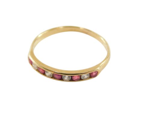 A ruby and cz nine stone ring, in a rub over setting, yellow metal, unmarked, size M½, 1.4g. 