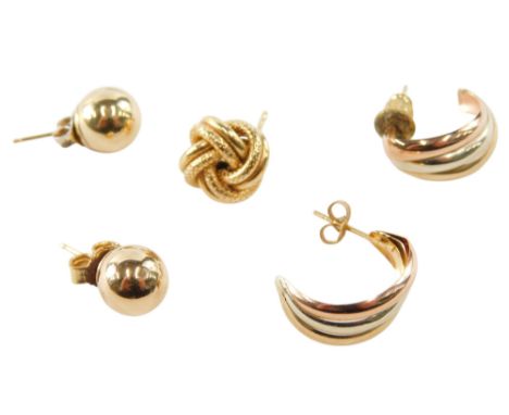 A pair of 9ct three colour gold earrings, pair of gold ball stud earrings, and a single knot earring, 2.5g. 