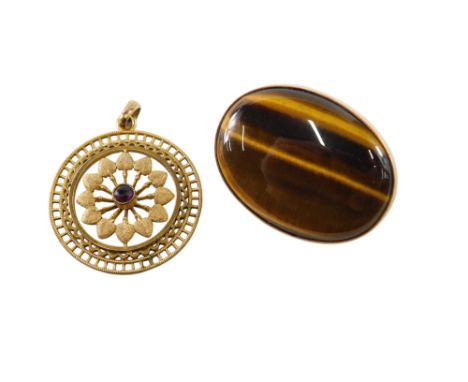 An oval cabochon tiger's eye brooch, in a yellow metal mount, unmarked, together with an amethyst and yellow metal circular p