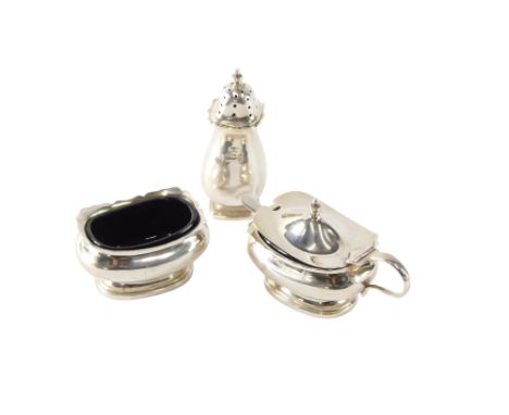 An early 20thC silver cruet, comprising salt and mustard pot with blue glass liners, and a pepper pot and spoon, all marks in