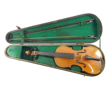 A German Stradivarius copy violin, with two piece back, 35.5cm long, and two bows, in ebonised wooden case.