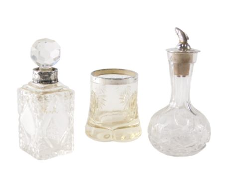 A cut glass bottle, the silver stopper cast with a fish, possibly a salmon, a cut glass scent bottle with silver collar, and 