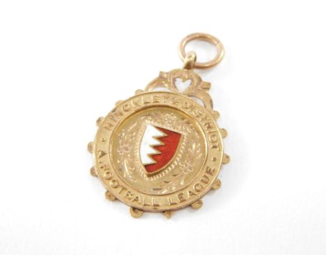 A 9ct rose gold and enamel medallion, for Hinckley &amp; District Football League, verso engraved Gold Medal Competn H&amp;DF