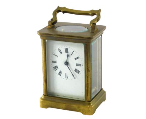 A French brass carriage time piece, with white enamel dial and Roman numerals, 15cm high.