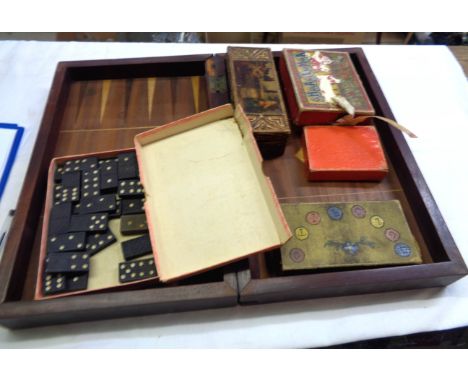 A folding wooden chess and backgammon board - sold with assorted games