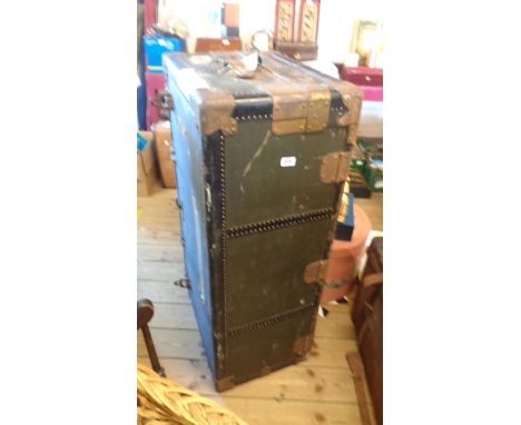 A vintage Winship Wardrobe travelling trunk with original wood hangers, lift-top and metal bound corners
