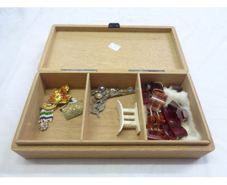 A vintage wooden cigarette box containing a small quantity of costume jewellery