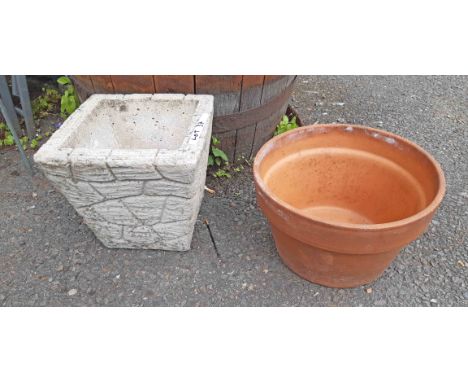 A terracotta plant pot and concrete brick form planter