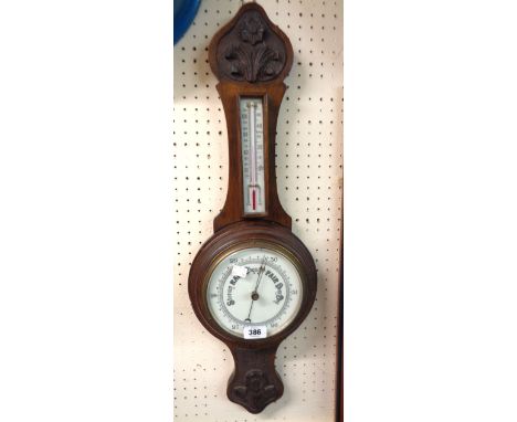 An early 20th Century stained oak cased banjo thermometer/barometer with printed dial, scale and aneroid works - crack to dia