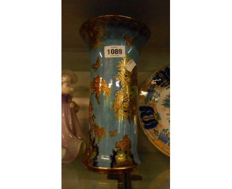 An Art Deco Carltonware lustre vase decorated all over with birds, butterflies and trees in coloured enamels with gilt