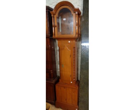 A reproduction polished pine longcase clock case with flanking bobbin quarter columns to trunk