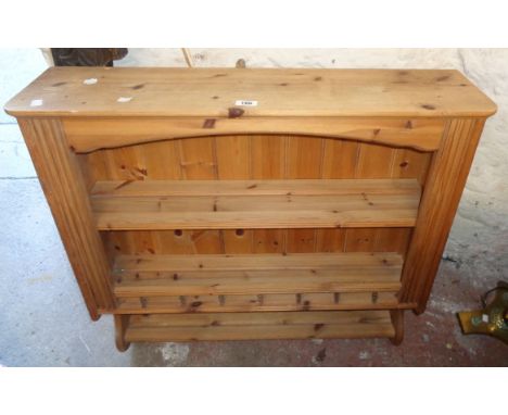 An 87cm modern pine wall mounted three shelf open plate rack with spindle decoration