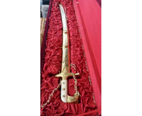 A boxed modern reproduction cavalry officer's sword with decorative scabbard