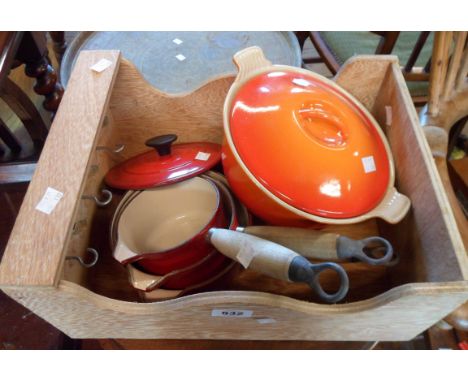A box containing a Le Creuset cast enamel casserole dish and a similar Cousances saucepan set