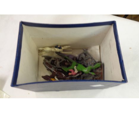 A box containing vintage lead figures and horses, etc.