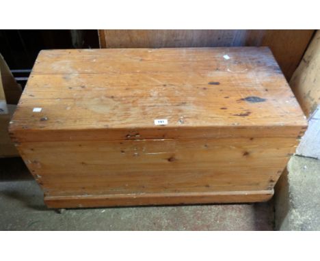 A 91cm 20th Century pine lift-top trunk with flanking drop handles, set on casters