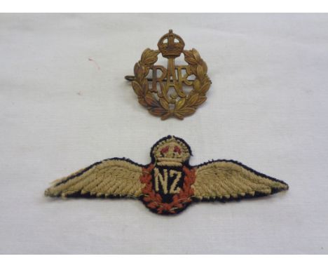 An RAF cap badge - sold with a World War II New Zealand Air Force uniform patch
