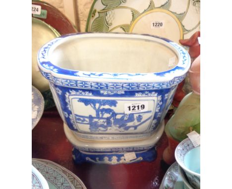 A modern Chinese blue and white porcelain planter and stand