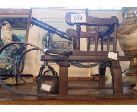 A vintage wooden model of a sled - sold with a small metal cowbell and cast brass decorative key