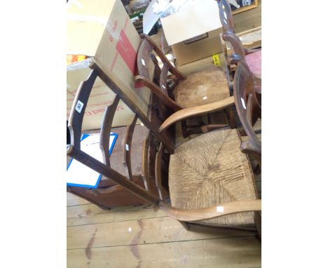 An old beech framed ladder back elbow chair with woven rush seat - sold with a Windsor kitchen chair with solid elm moulded s