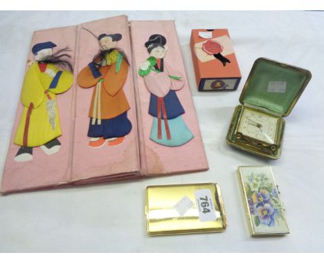A Japanese embroidered folding table centre decorated with figures in local dress - sold with a travelling alarm clock, two c