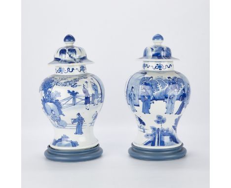 Pair of Chinese blue and white porcelain lidded baluster jars. Decorated along the bodies of the jars with outdoor court scen