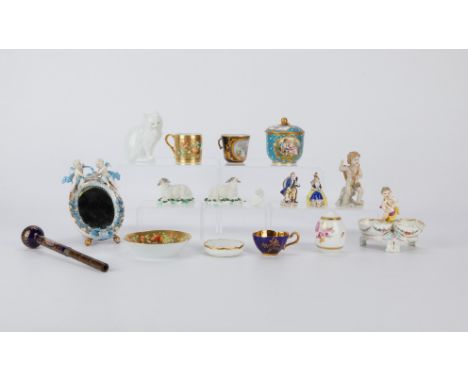 Group of 16 European porcelain pieces including figurines of cats, sheep, and people, teacups, dishes, a mirror, and a scepte