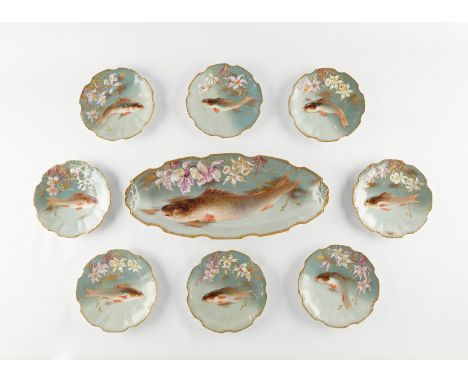 Limoges, France. Set of hand painted porcelain fish plates, including one serving dish with eight small round plates. All are