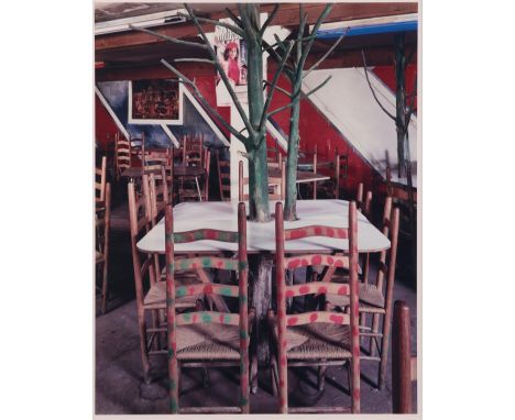 Birney Imes (American, b. 1951). Photograph depicting a plethora of tables and chairs, one encircling a tree. Chromogenic pri