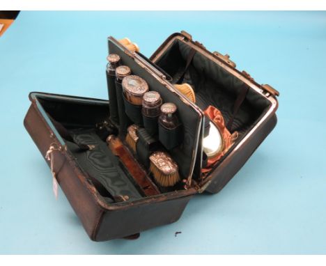 A late Victorian Gladstone-type vanity case, five glass bottles with embossed silver covers, London 1897, includes glove-stre