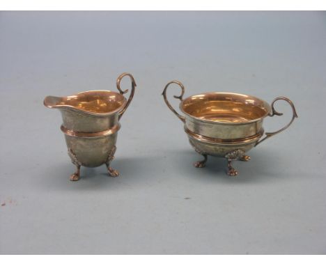 A silver cream jug and matching two-handled sugar bowl, helmet-shape cream jug, Birmingham 1923, two-handled sugar bowl, Birm