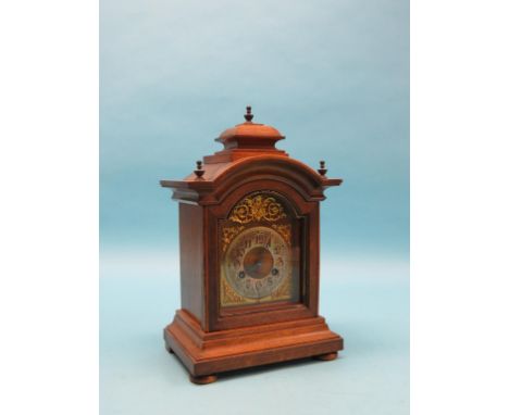 A late 19th century walnut mantel clock, traditional arched dial and eight-day German gong-striking movement, architectural w