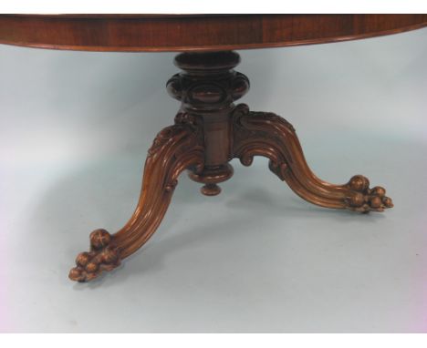 An early Victorian rosewood breakfast table, circular top tilting upon turned stem and carved tripod legs with casters, top 4