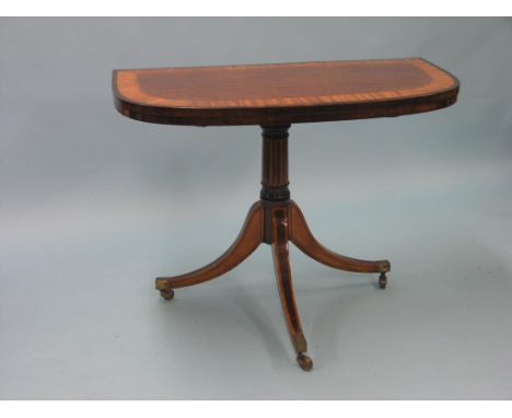 A George III mahogany card table with rare hinged leaf-support mechanism, D-shape top with broad satinwood cross-banding and 