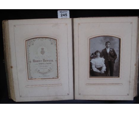 Victorian photograph album with moulded figural and leather bindings, brass clasp, containing a good selection of individual 