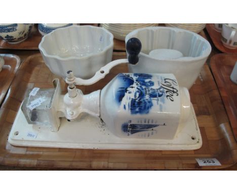 Two ceramic vintage jelly moulds, together with blue and white coffee grinder with wall bracket depicting Dutch windmill and 