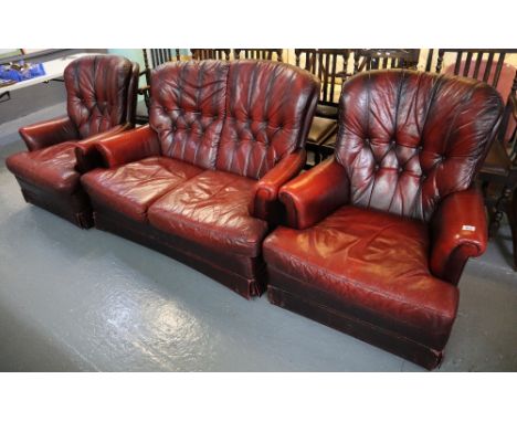 Modern ox blood Chesterfield type button back three piece suite comprising; two seater sofa and a pair of armchairs. (B.P. 24