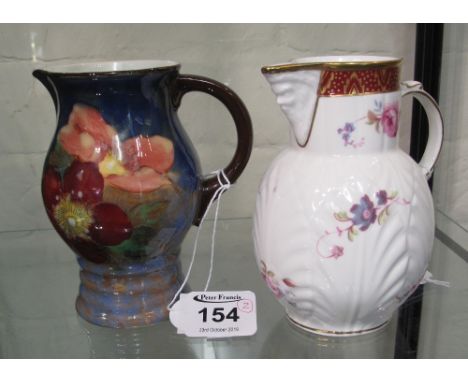 Caughley mask head jug produced by Coalport, together with Royal Doulton floral jug of baluster form. (2)(B.P. 24% incl. VAT)