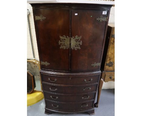 Reproduction mahogany bow front cabinet having four long drawers and bracket feet, possibly a cocktail cabinet, unable to ope