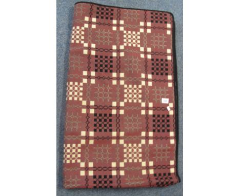 Red and green ground black edged woollen vintage Welsh tapestry blanket with geometric design, probably from the Elvet woolle